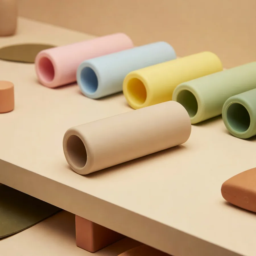 TPR treat roller in pastel colorways on a sampling bench for interactive dog toys wholesale QC