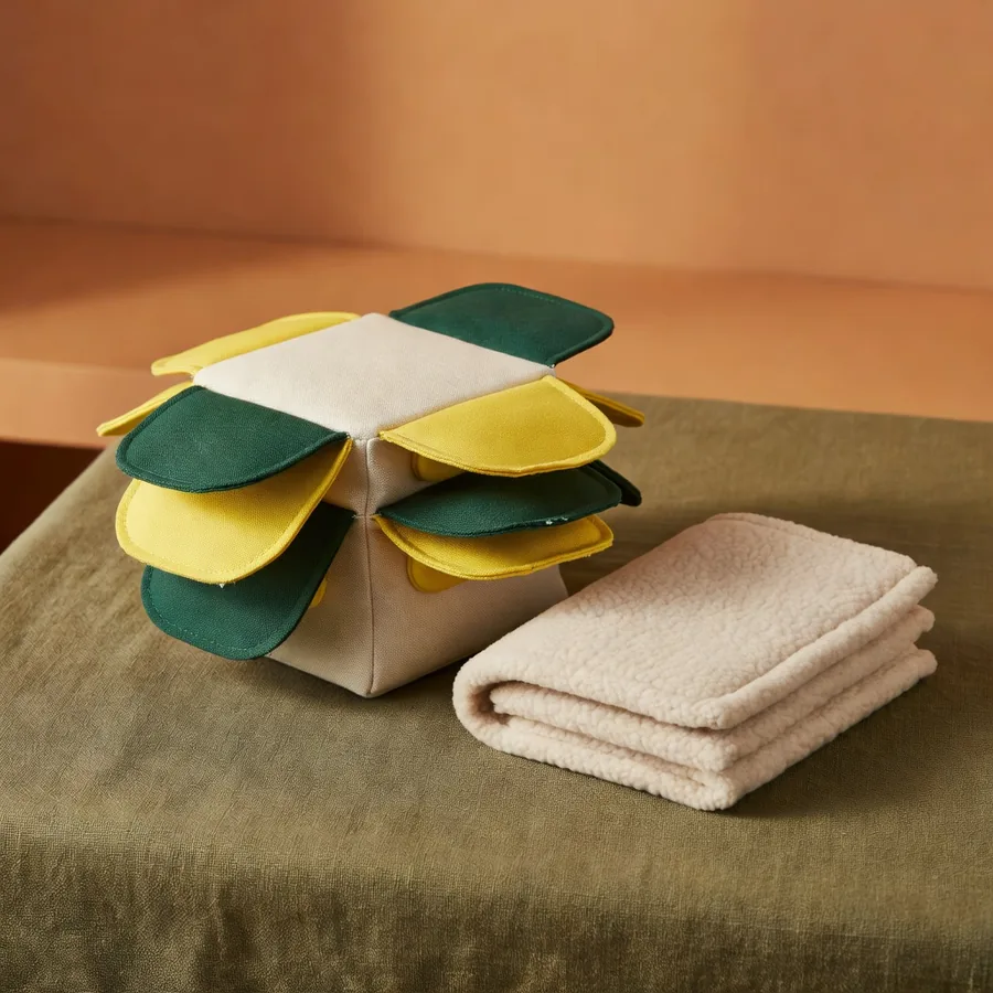 Cotton and TPR snuffle box beside a folded fleece slow feeding mat
